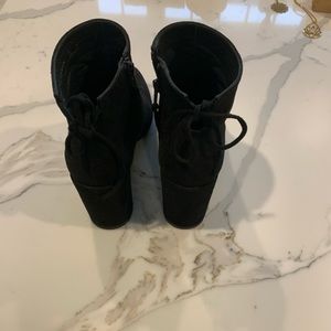 Stuart Weitzman bootie. Decorative back tie, side zip, 1.5 block heel.